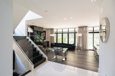 Designs by Santy :: Escarpment Modern Contemporary foyer with staircase, glass rail and great room