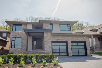 Designs by Santy :: Escarpment Modern Contemporary front exterior with stone, stucco and front roof