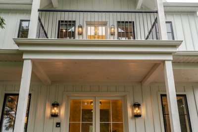 Designs by Santy :: Coastal Farmhouse Front porch and balcony with white stained lumber and sconces