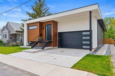 Designs by Santy :: Post House Modern front exterior with modern garage door and stucco