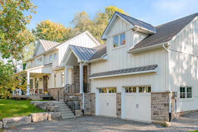 Designs by Santy :: Hilltop Farmhouse Front exterior with stone, board and batten, and two car garage