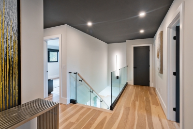 Designs by Santy :: Modern Luxury Contemporary landing with wood floor and glass rail