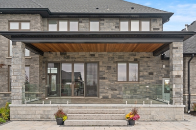 Designs by Santy :: Grand Estate Covered patio with stone, glass rail and wood soffit