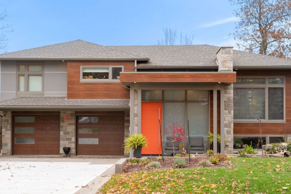 Designs by Santy :: Portico House Renovation Front exterior with wood siding, stone and grey panelling