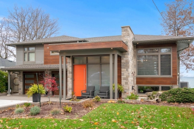 Designs by Santy :: Portico House Renovation Front exterior with wood siding, stone and grey panelling