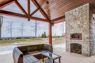 Designs by Santy :: Timber Entry Rear covered patio with timber accents and stone fireplace