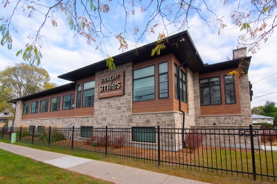 Designs by Santy :: Prairie Smiles Front exterior with stone, wood siding, and black windows