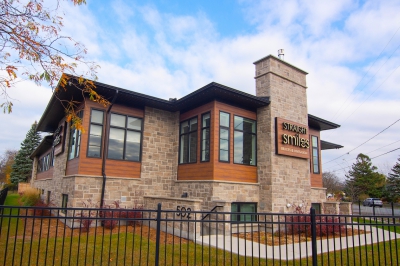 Designs by Santy :: Prairie Smiles Side exterior with stone, wood siding, and black windows