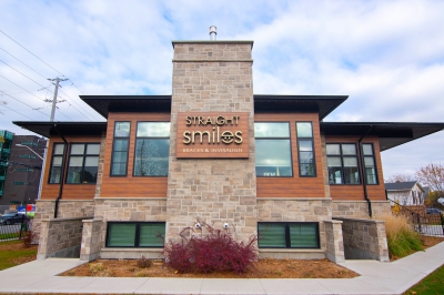 Designs by Santy :: Prairie Smiles Side exterior with stone, wood siding, and black windows