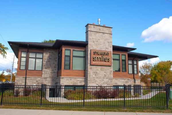 Designs by Santy :: Prairie Smiles Side exterior with stone, wood siding, and black windows