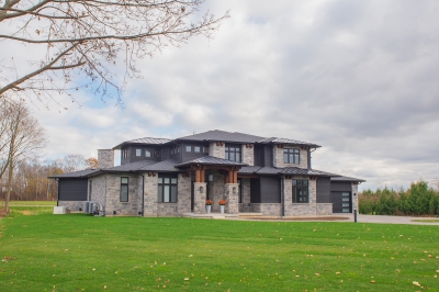 Designs by Santy :: Regal Prairie Estate Front exterior with stone, black siding and timber accents