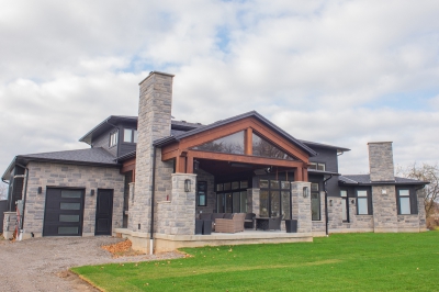 Designs by Santy :: Regal Prairie Estate Rear exterior with stone, timber accents, and covered patio